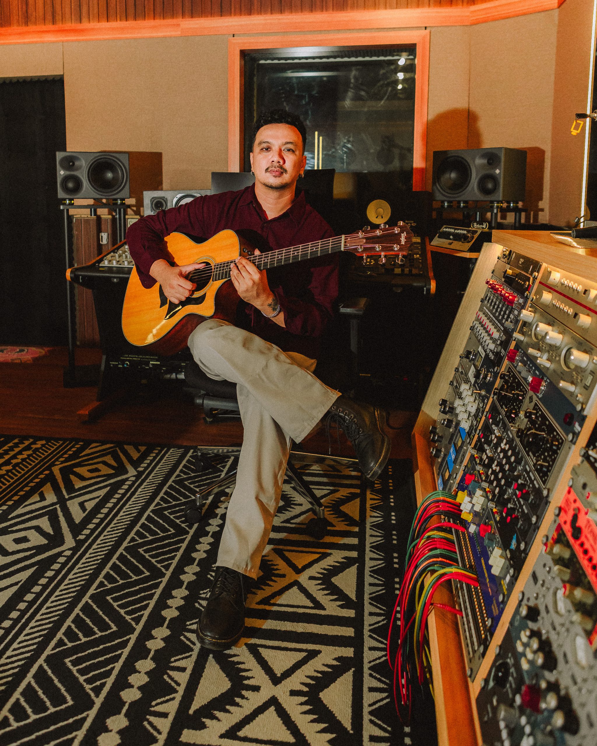 Kevin Pangestv with acoustic guitar in studio